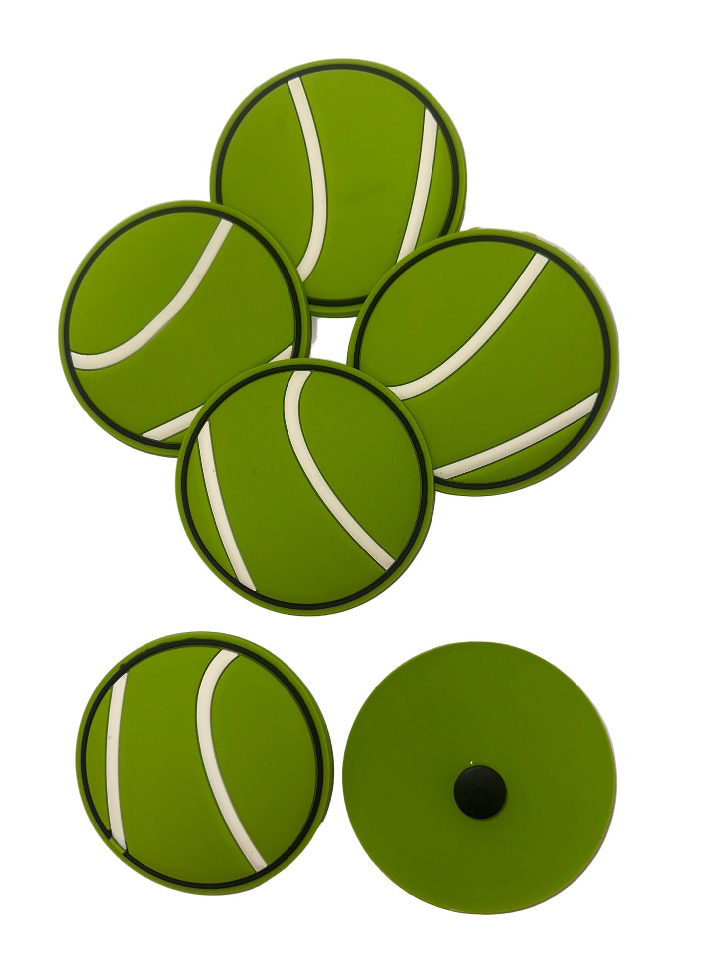 Green coasters with white stripes resembling tennis balls on a white background