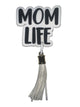 Decorative keychain with 'MOM LIFE' text and tassel on a gray background