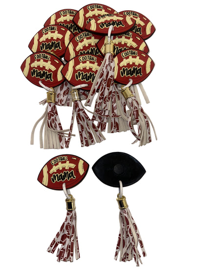 Football-shaped keychains with tassels on a white background
