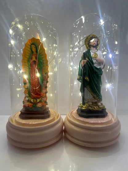 Decorative statue in a clear glass dome on a white background
