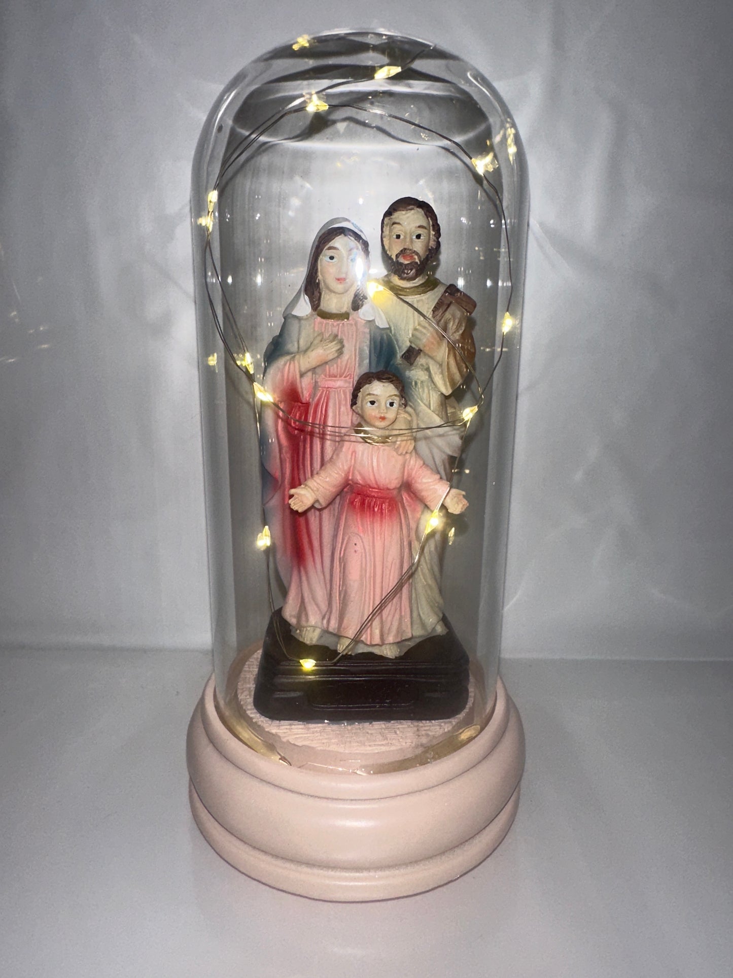 Decorative figure with LED lights inside a glass dome on a white background