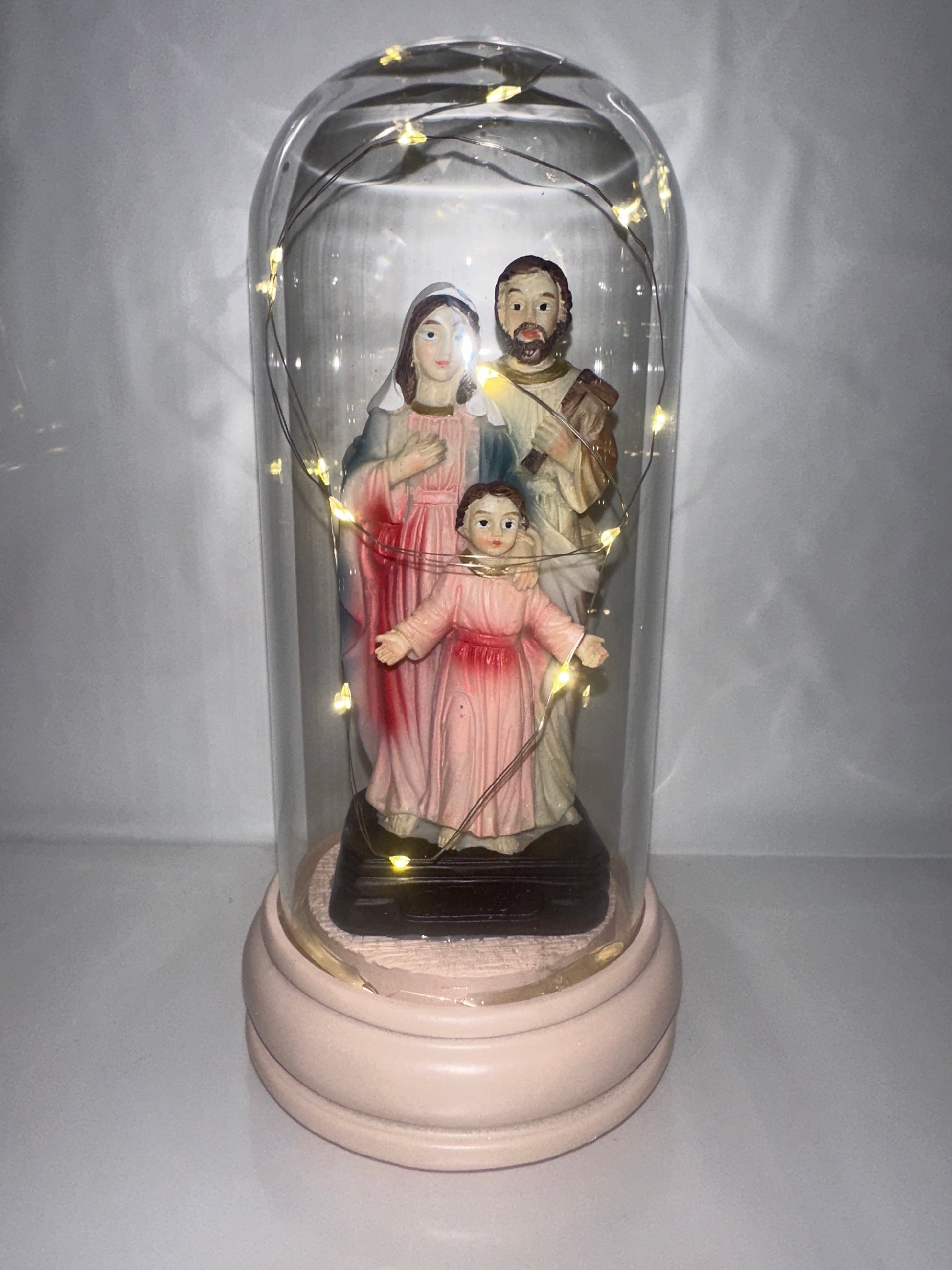 Decorative figure with LED lights inside a glass dome on a white background