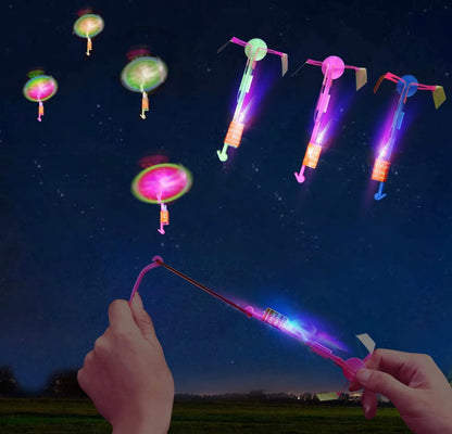 Colorful LED butterfly toys being launched into the night sky.